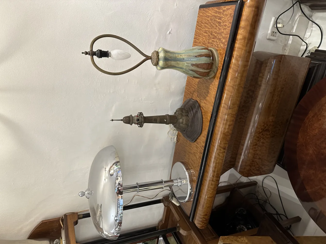 antique table lamp with a striking base and unique shape, decorating a wooden table