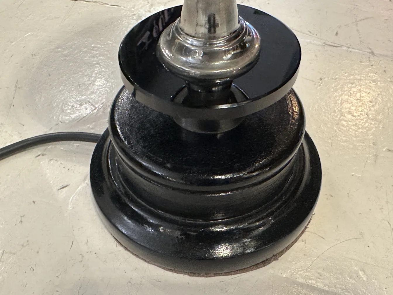 shiny black base of antique table lamp