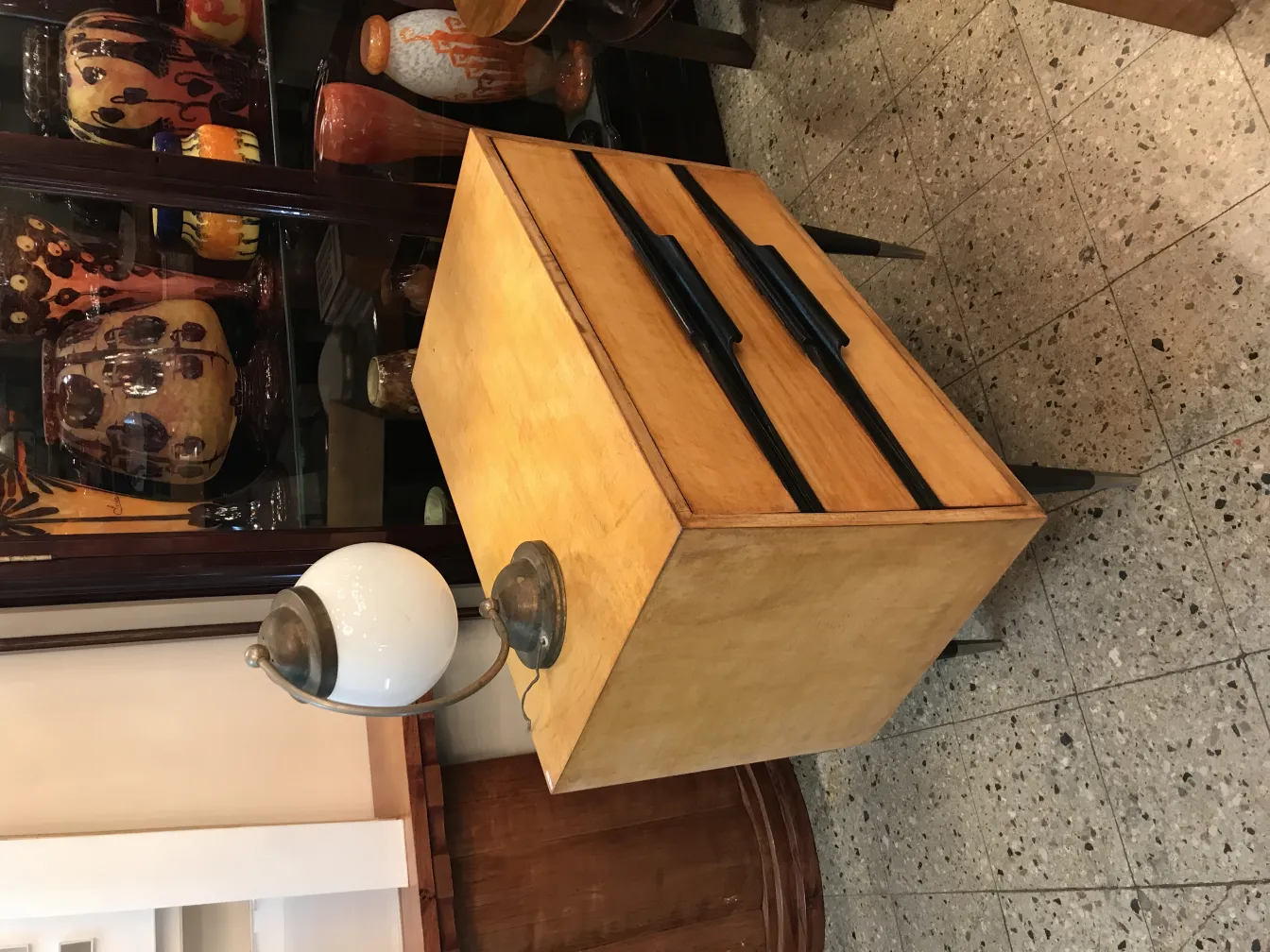Antique table lamp with a white globe and metal base, surrounded by decorative vases