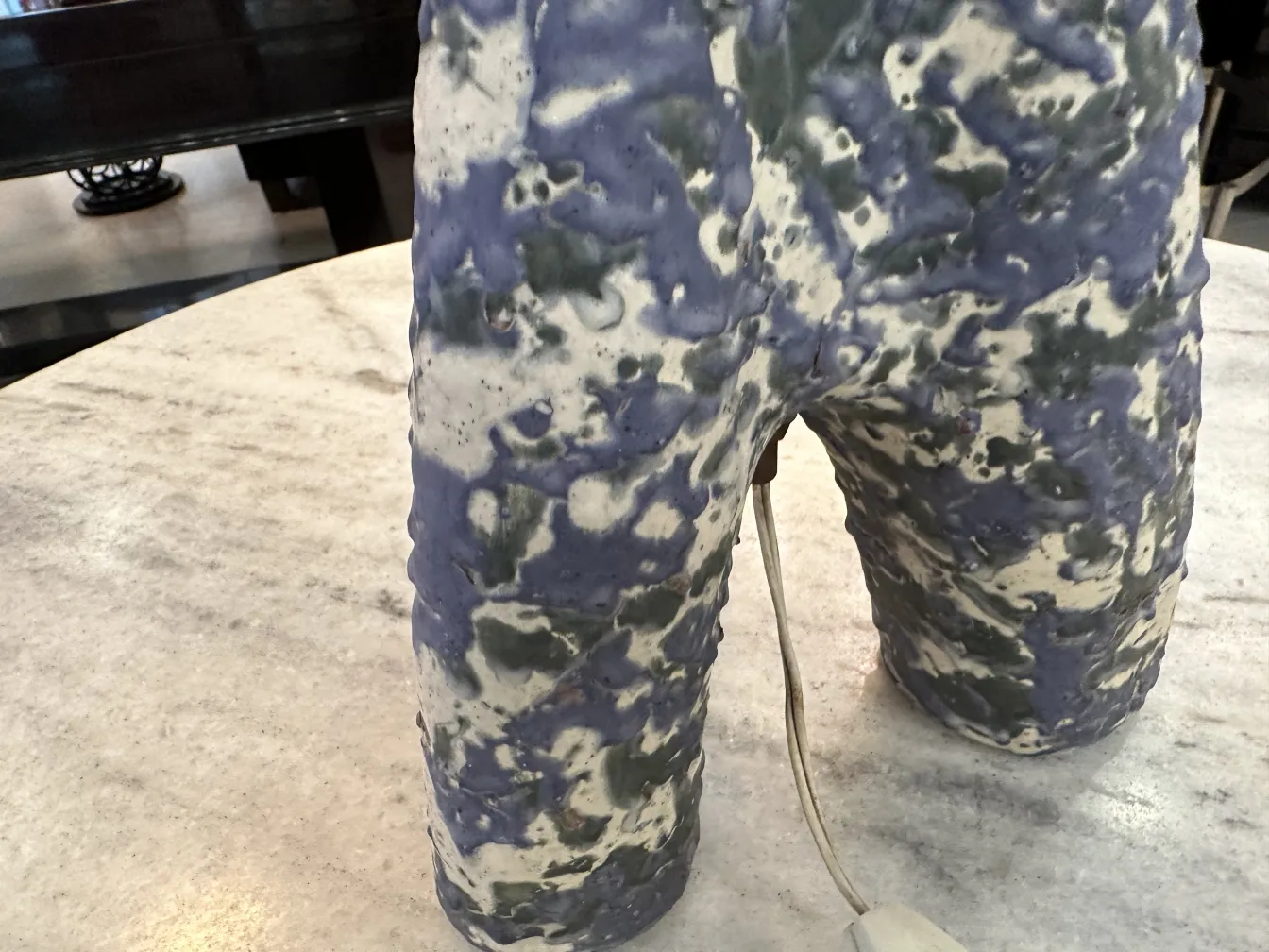 مصباح طاولة قديم بتصميم ملون وتفاصيل فريدة، في بيئة دافئة