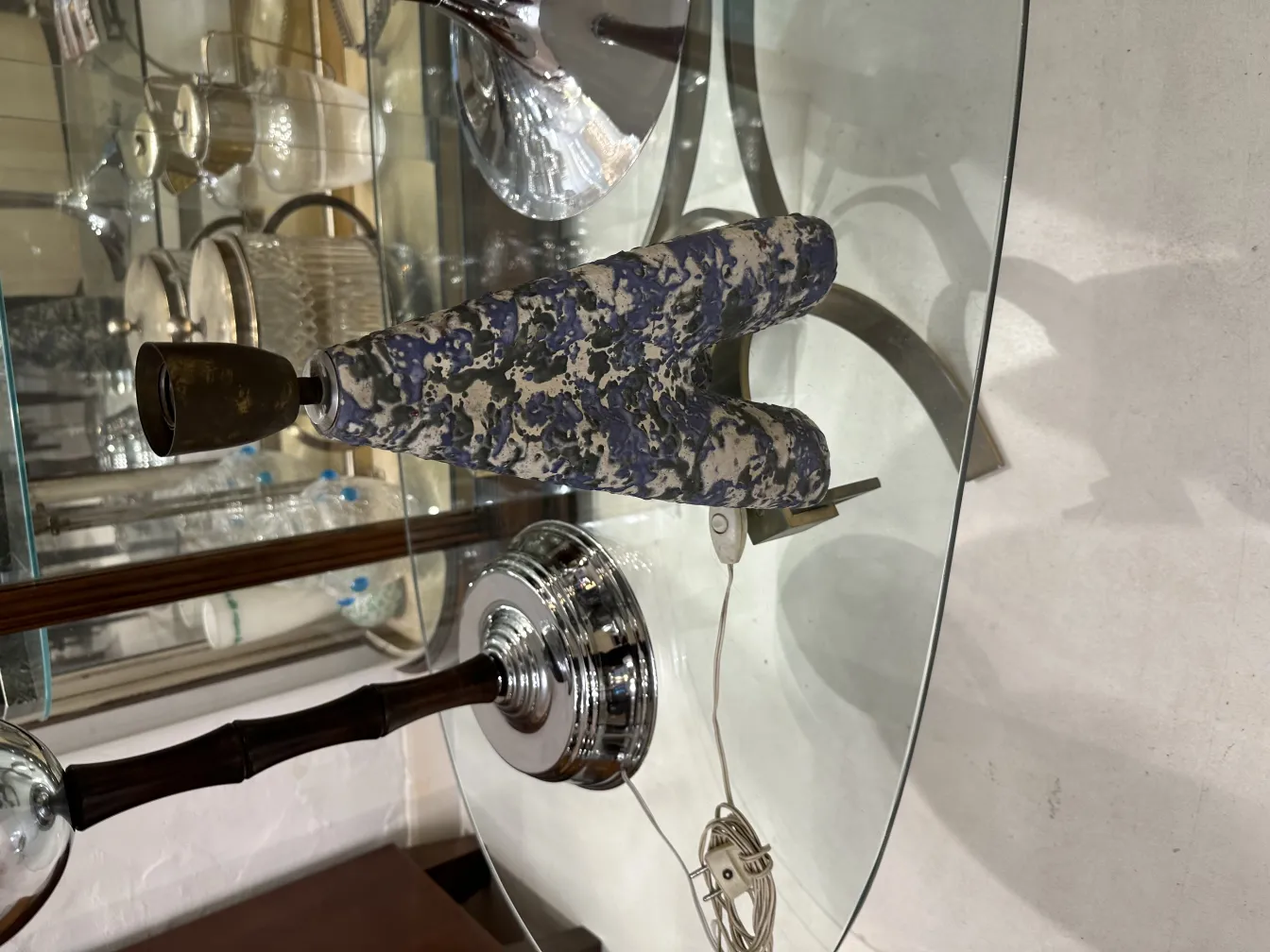 Antique decorative table lamp with shiny base and colorful details.