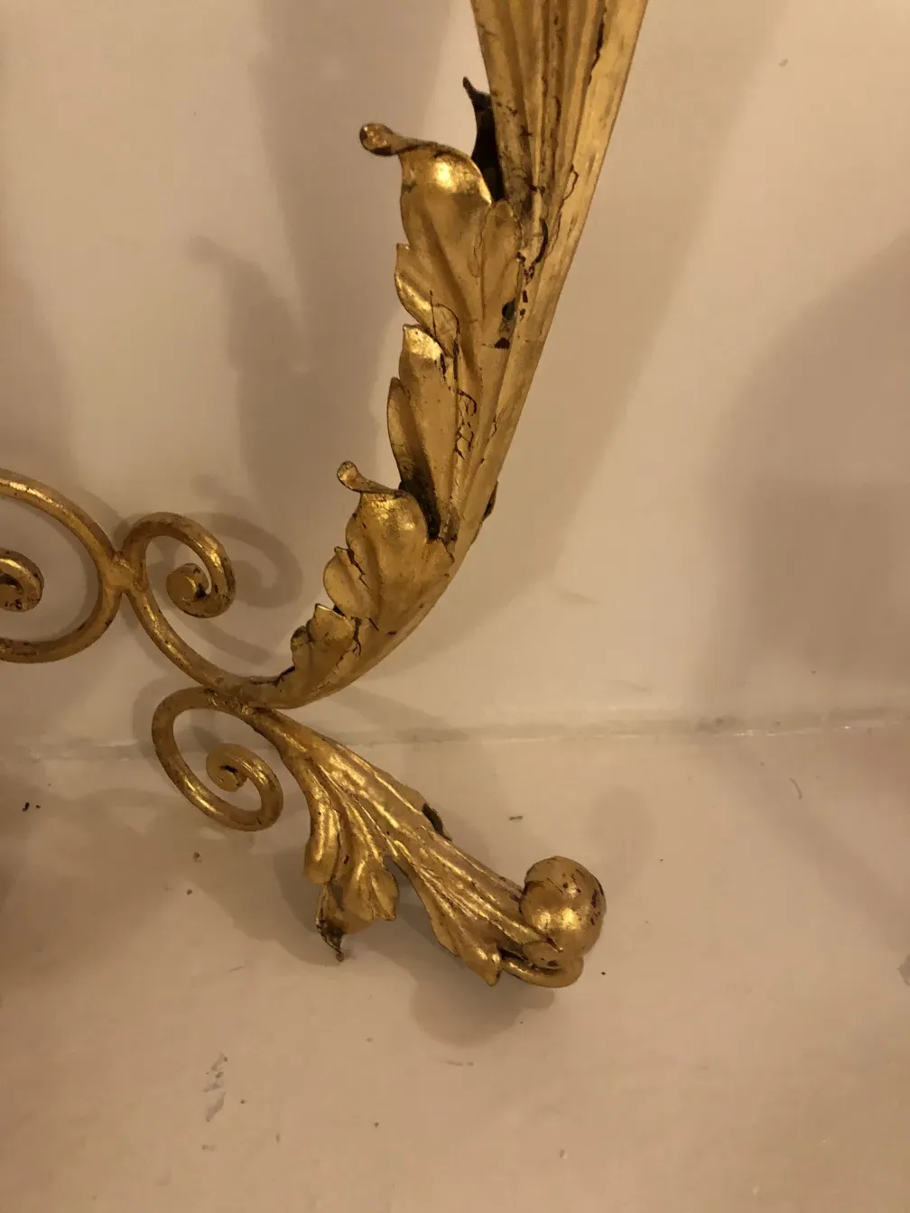 detail of an antique console with golden finish