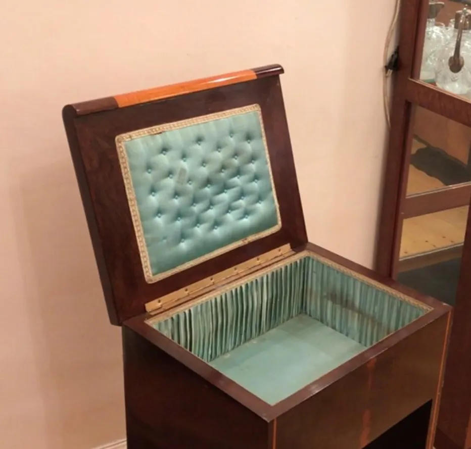antique console with blue cover and decorative interior