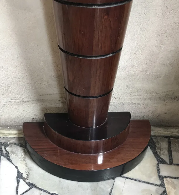 antique console table with a stylized base and rounded edges