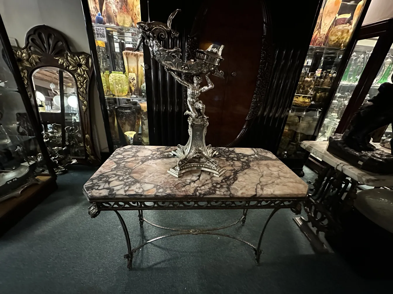 Consola antiga com design decorativo e ambiente elegante, cercada por itens históricos.