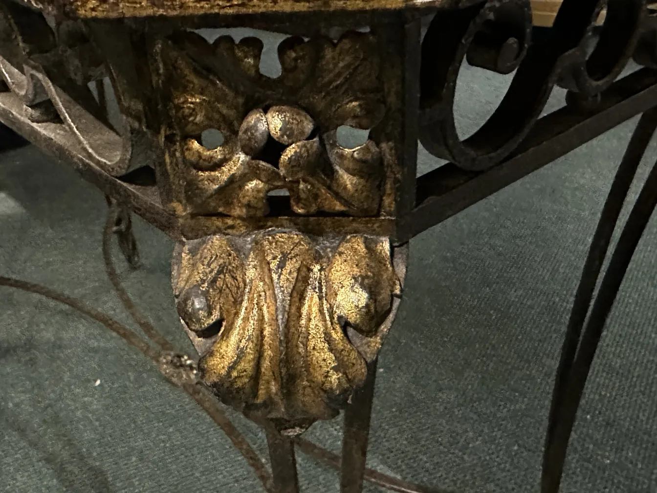 View of an antique console with ornamental details on the base, elaborate and decorative.