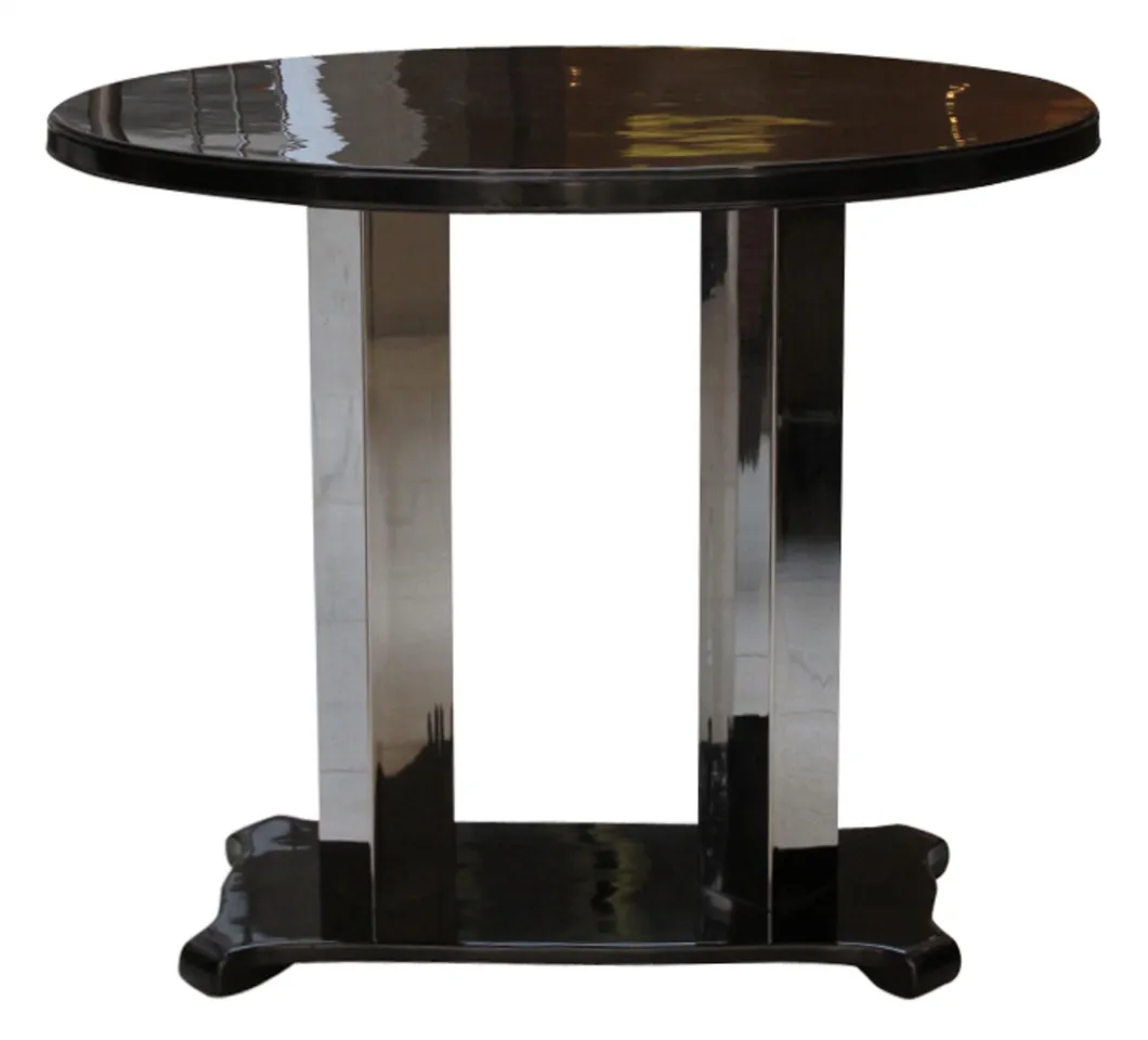 Ancienne table console ronde avec base élégante dans un cadre neutre.