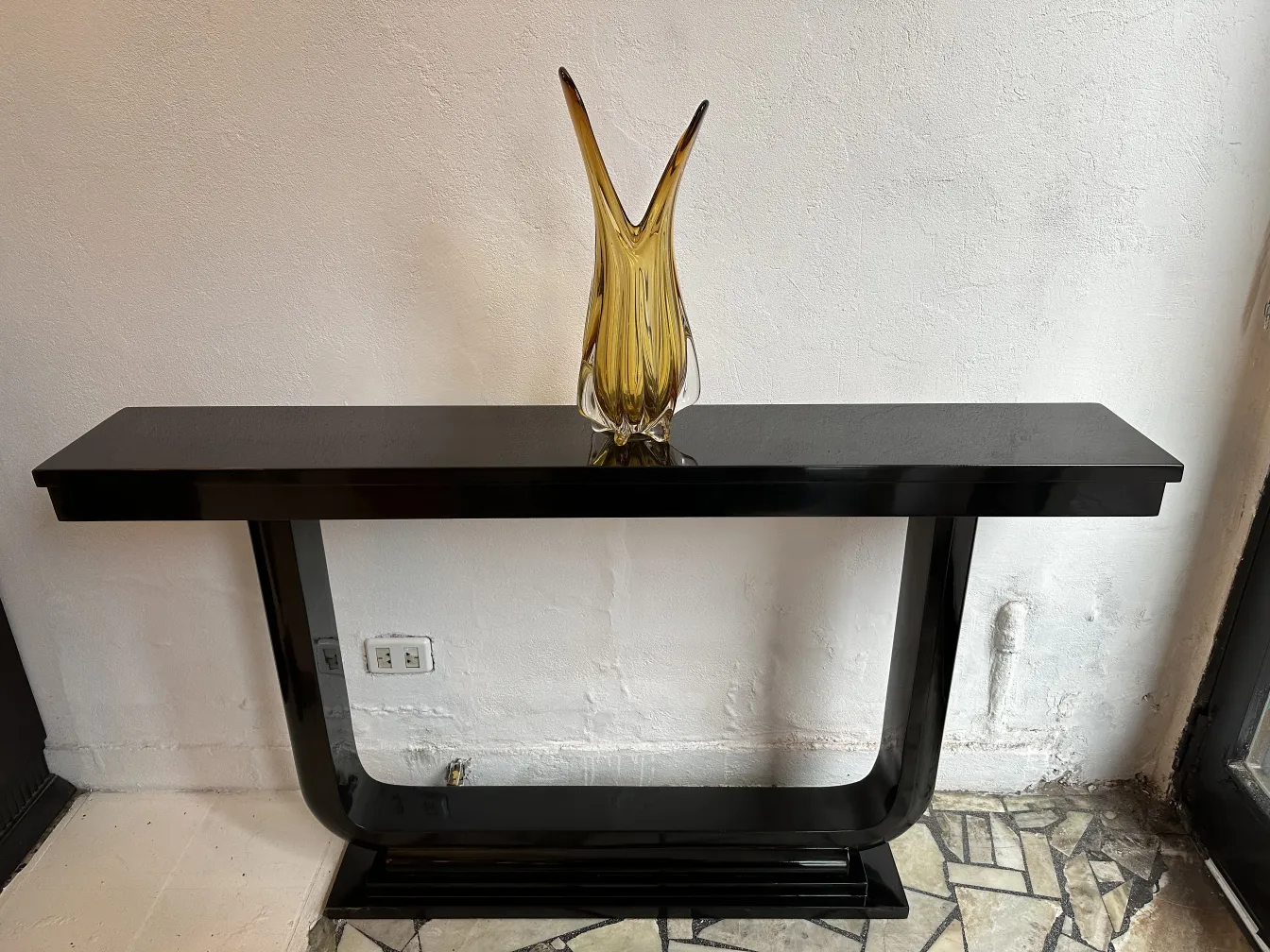 two elegant antique consoles with a decorative vase