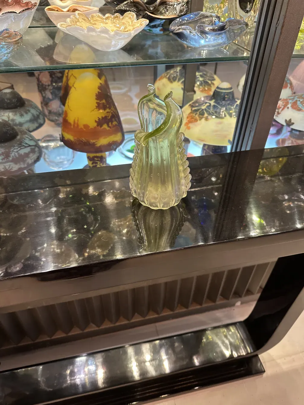 duas consoles antigas decorativas em uma vitrine