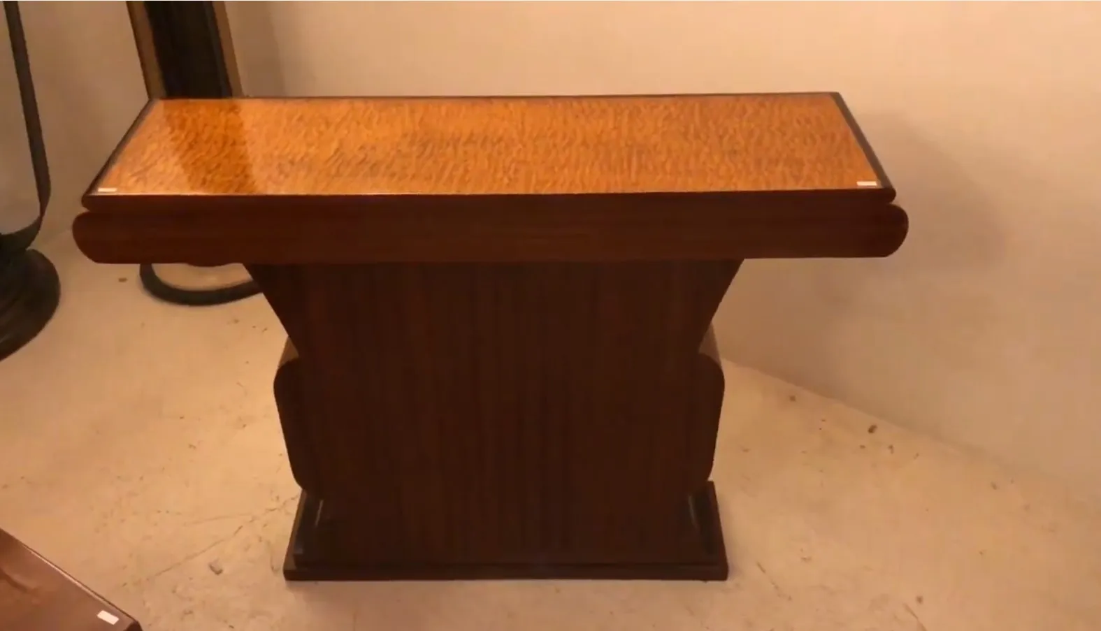 Side view of two elegant antique consoles in a stylish setting