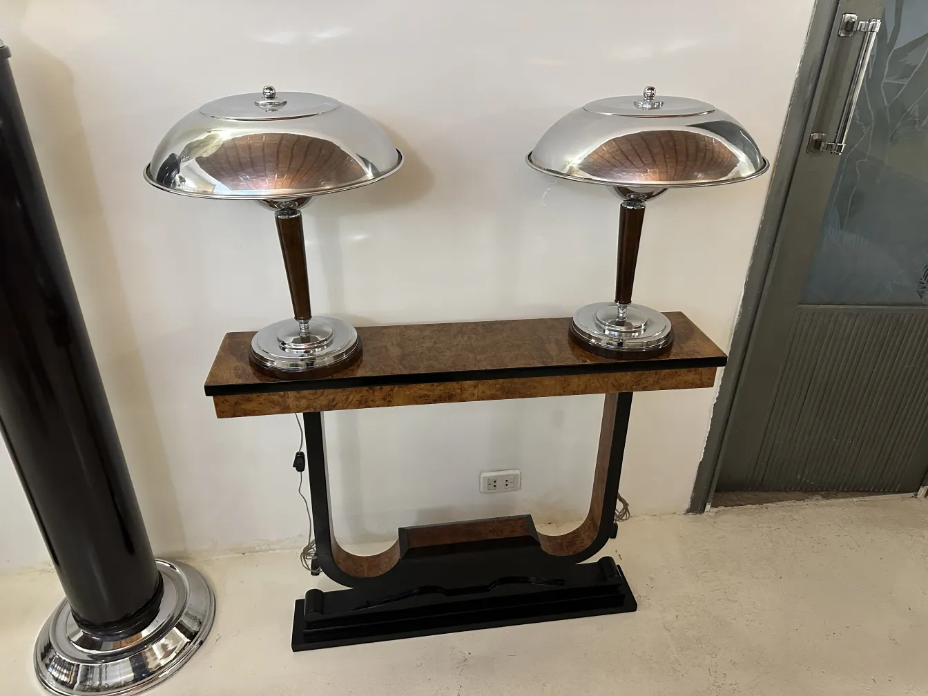 three antique consoles with lamps in a modern setting