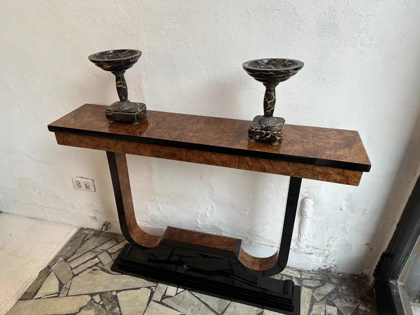 three antiqued consoles with decorative bases, neutral setting