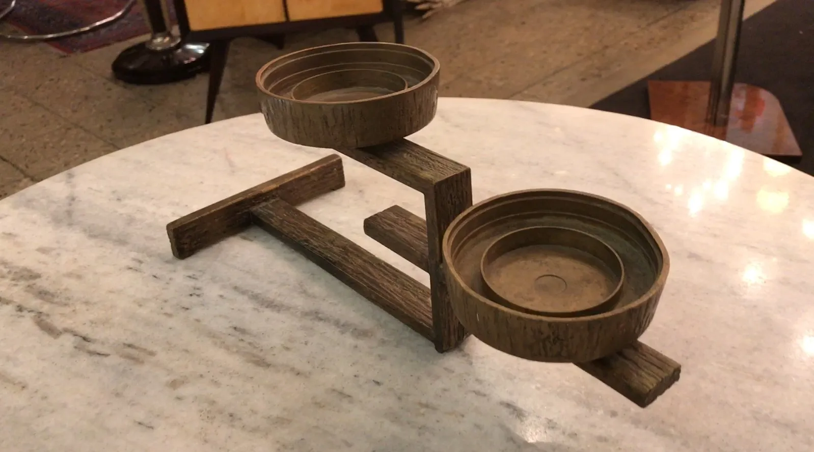 antique candelabra with circular cups on a table