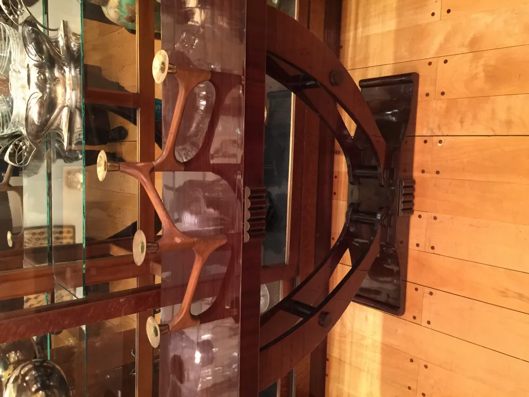 Antique candelabra elegantly designed with decorative features and light wood background