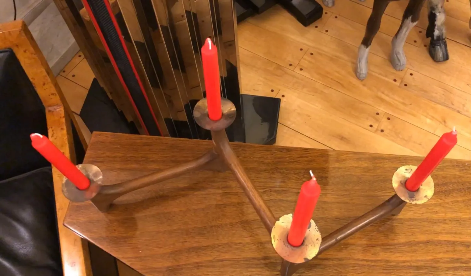 antique candelabra with red candles on a wooden table in a classic setting