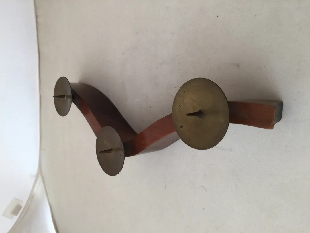 candelabro antiguo con diseño curvado y tres bases para velas