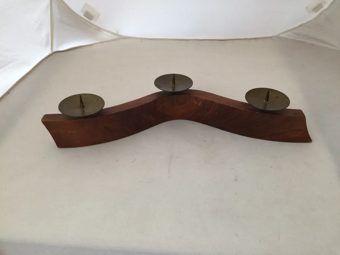 candelabro antigo com design curvado e três suportes para velas