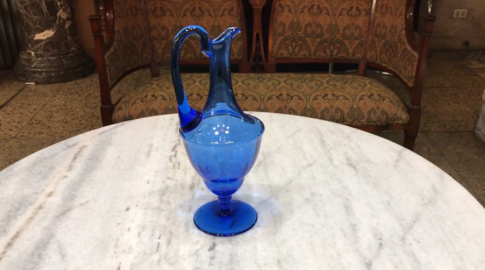 antique blue glass jar on a marble table