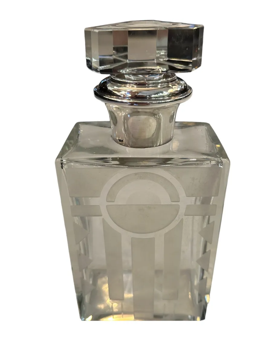 Antique bottle with decorative design and shiny cap