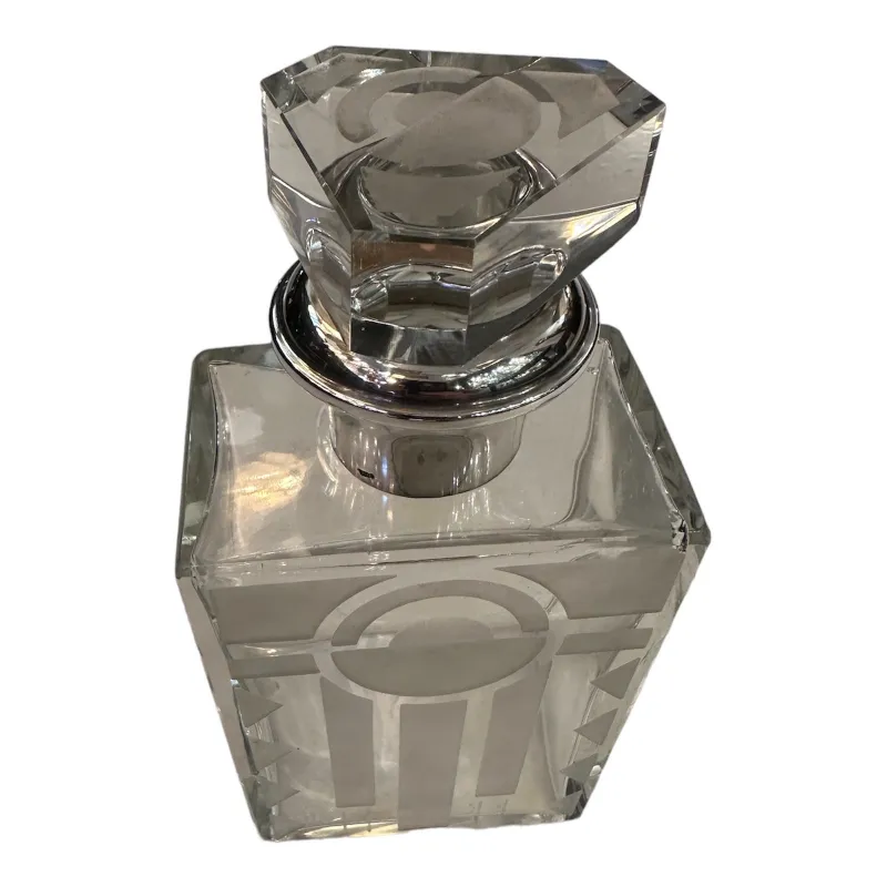 Glass bottle with faceted lid and elegant design in a classic setting