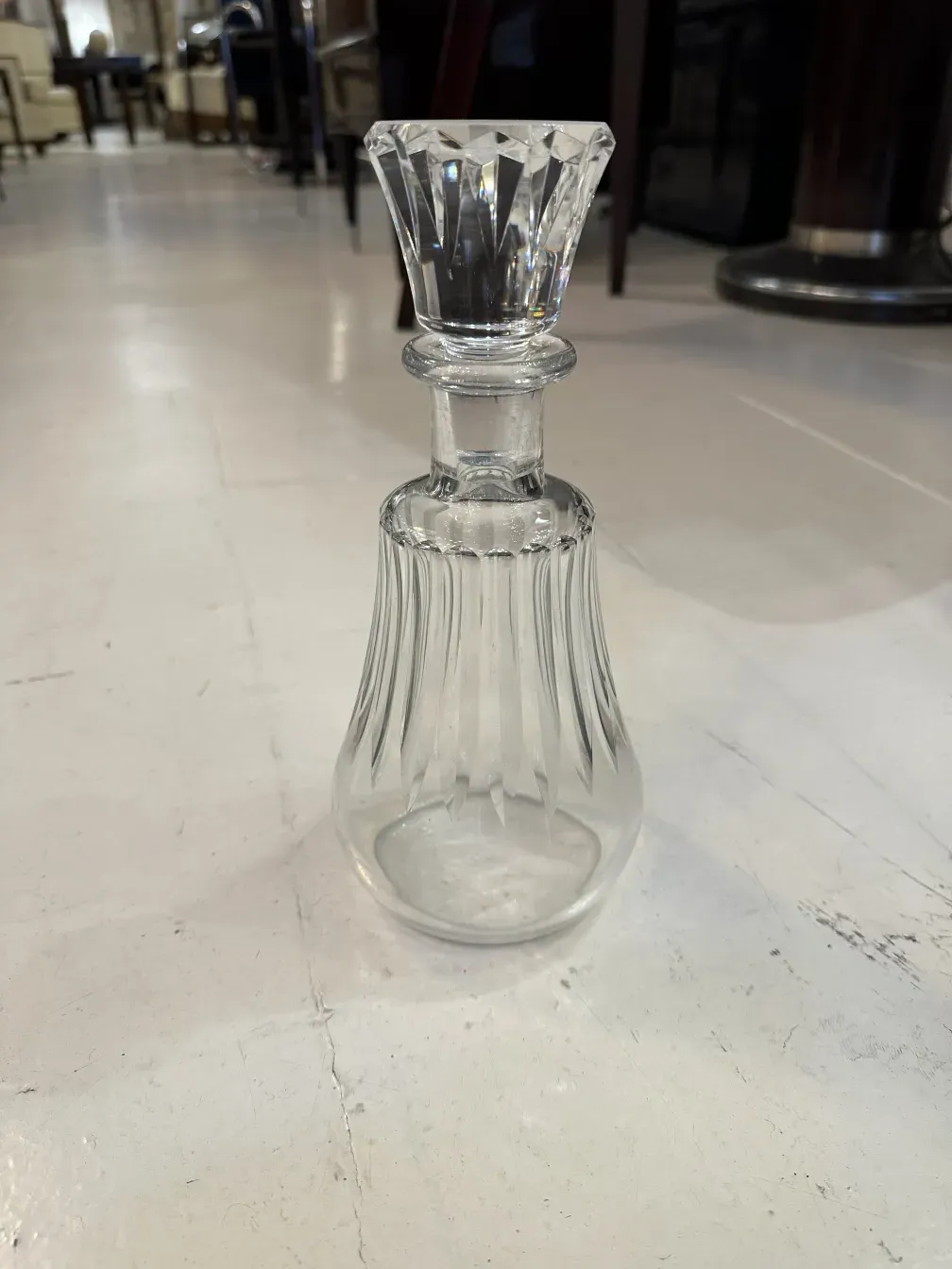 antique bottle with a cup and decorative lines