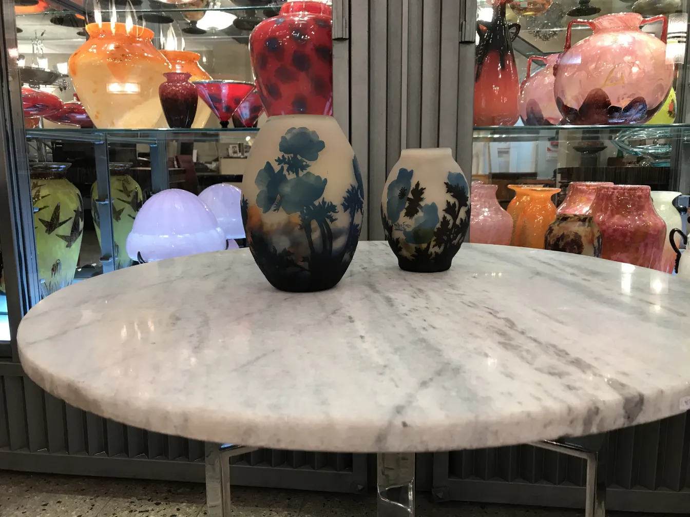 two vases with floral design, one large and one small, colorful background