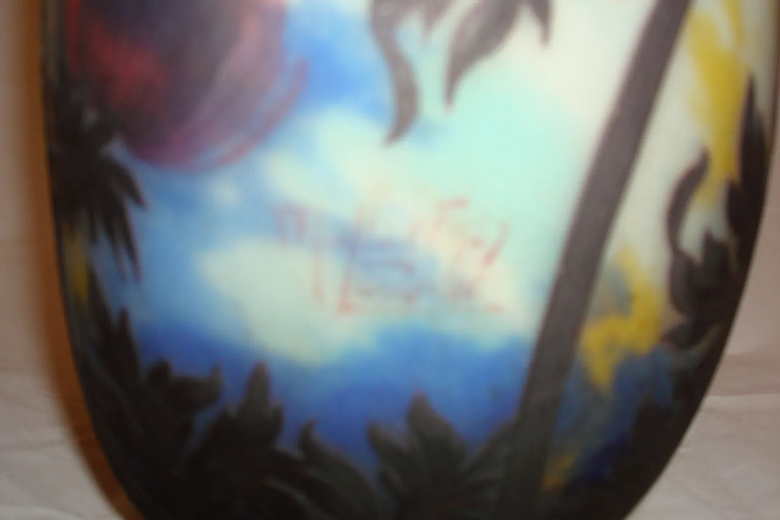 antique signed glass by muller fres with a colorful background