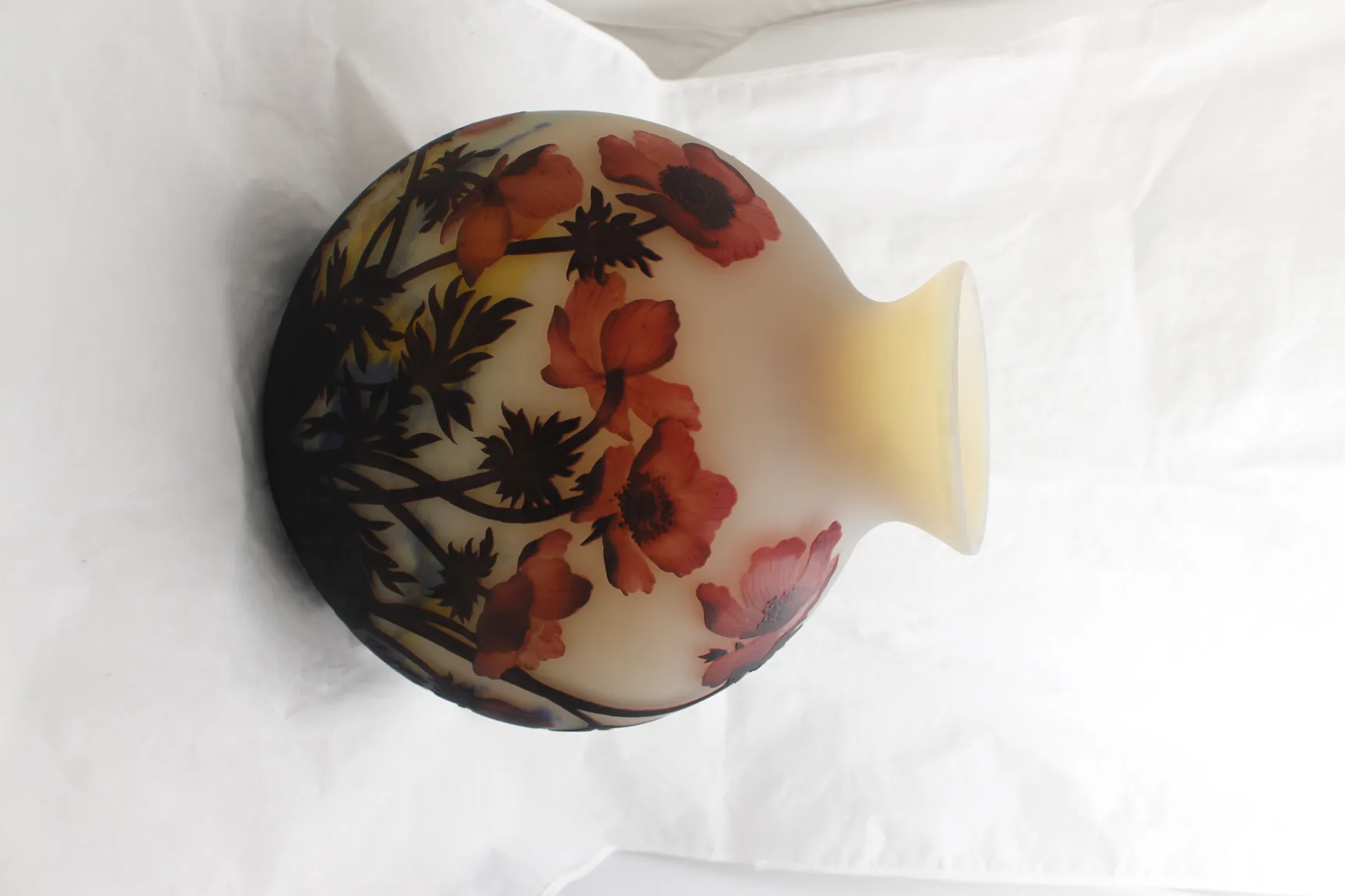 Side view of a signed glass Muller Fres with floral design, light background.