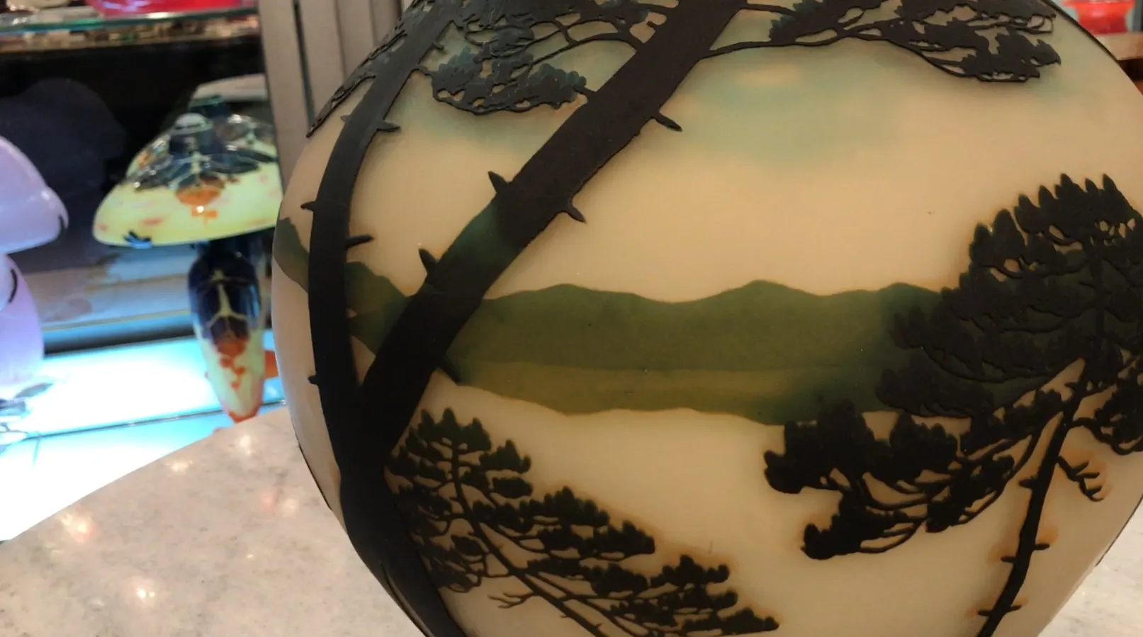 Antique signed glass Muller Freres featuring a landscape.