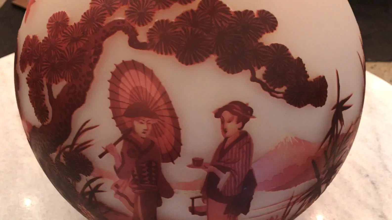 Antique glass featuring relief figures of people and scenery.