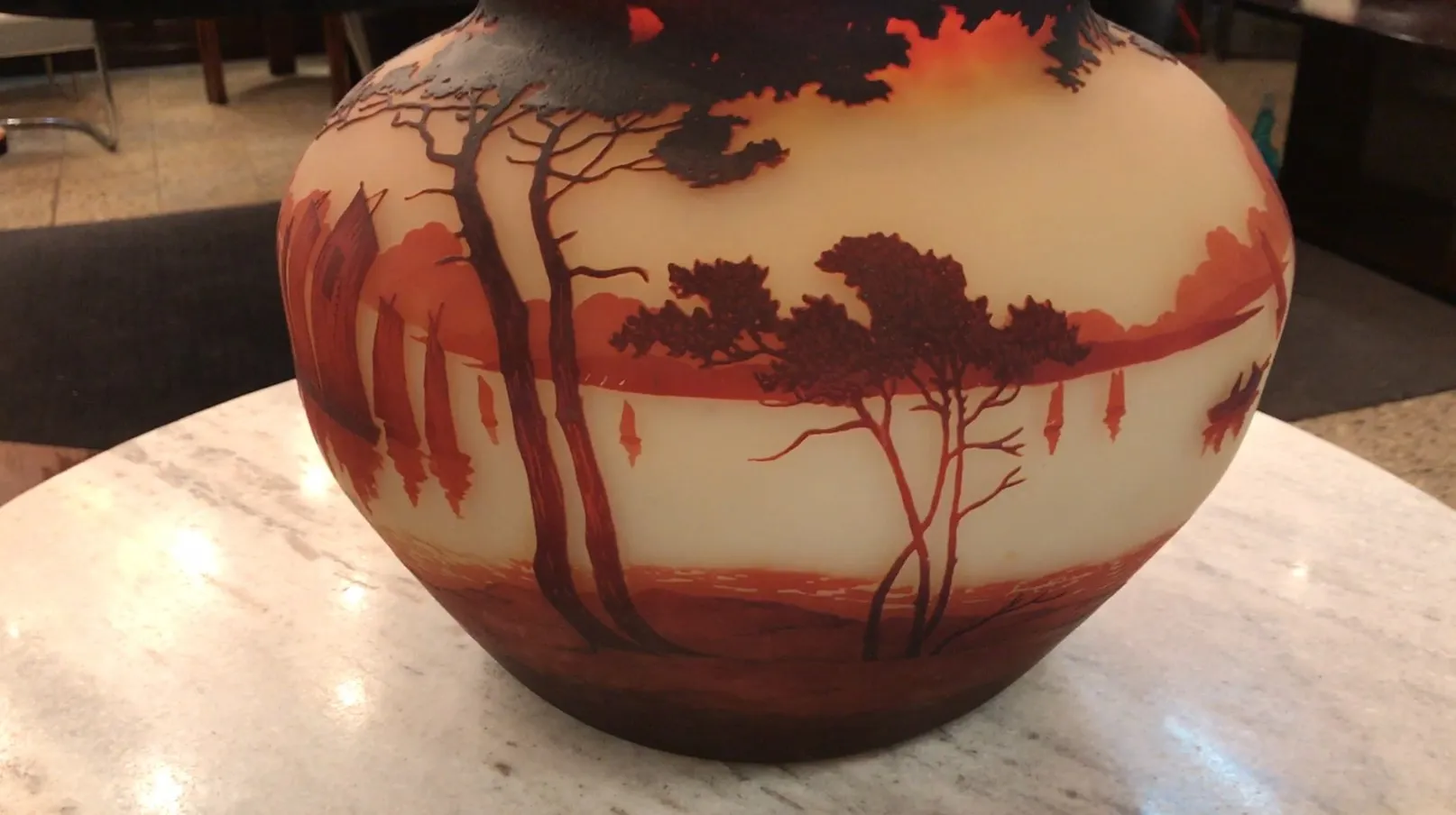 Antique glass signed by Muller Fres showcasing a landscape in orange and brown hues.