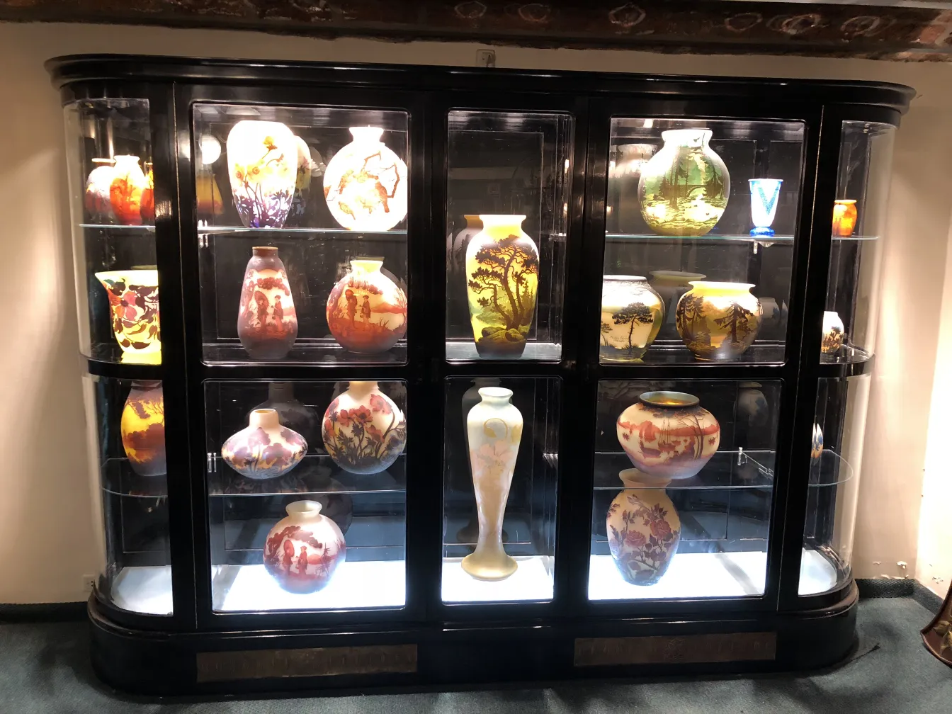 antique glass with painted details and Muller Fres signature in a display case