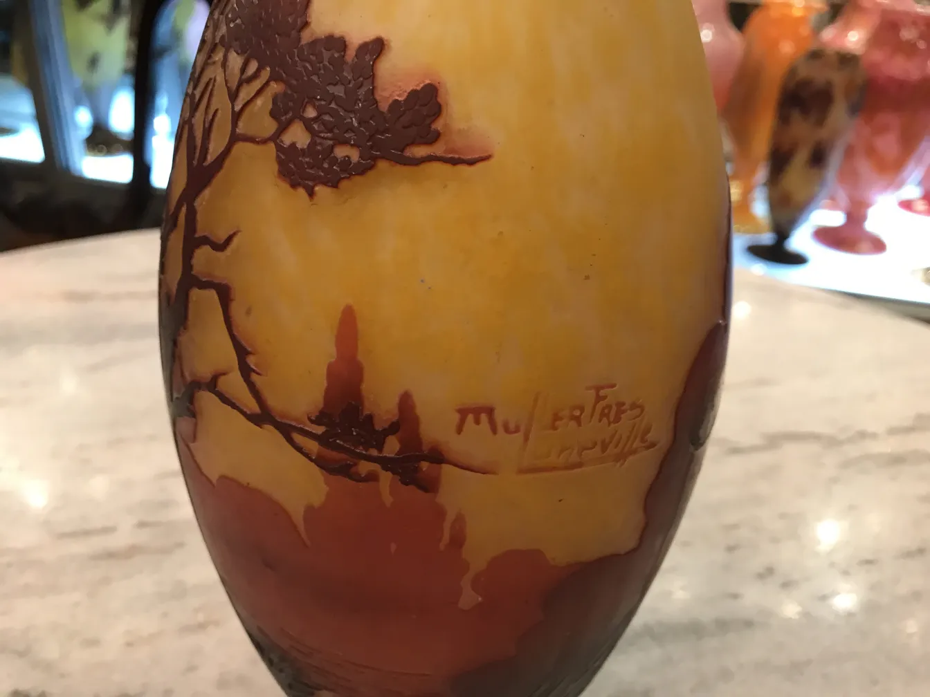 Signed glass by Muller Fres, warm colored background.