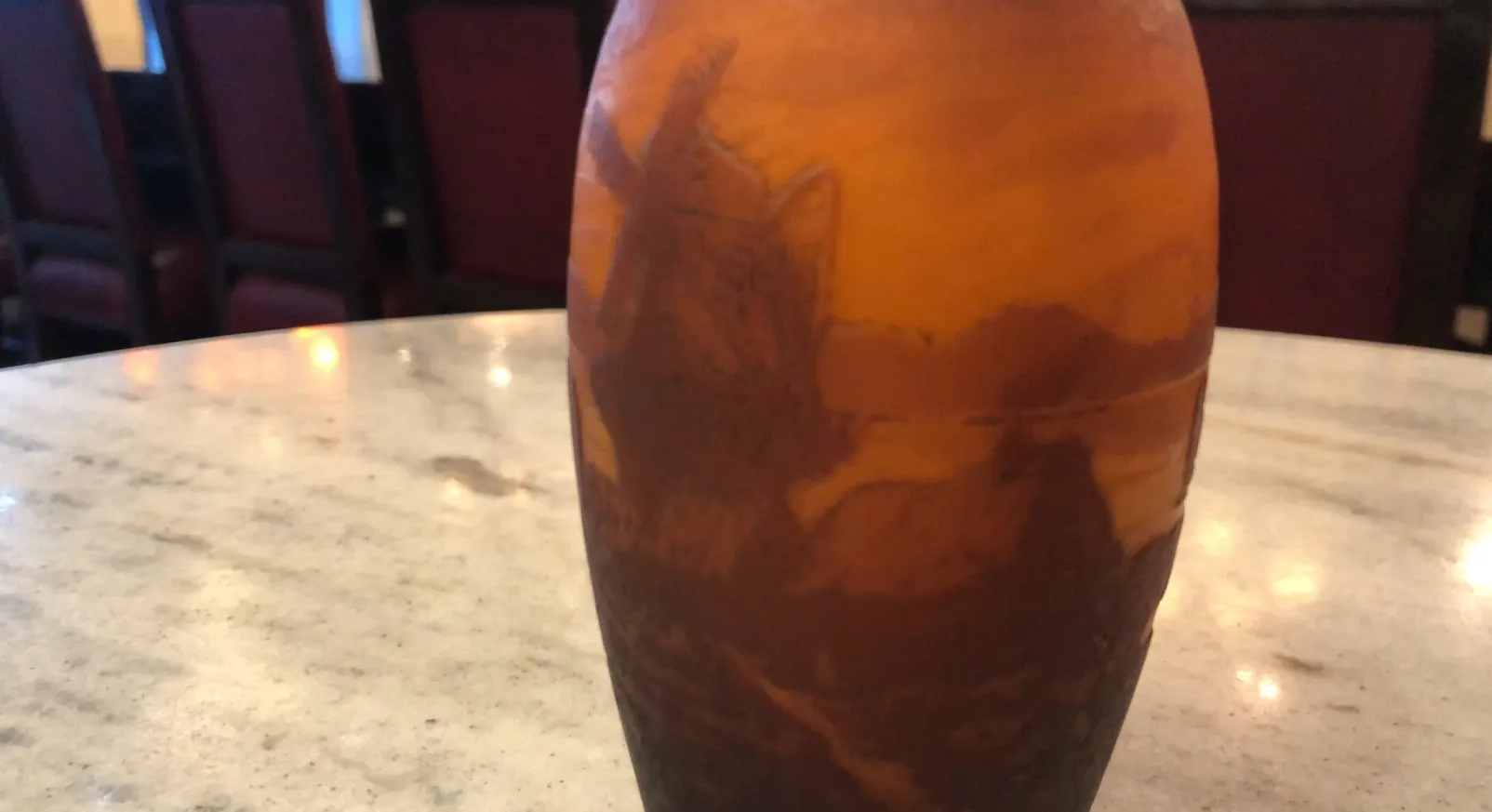 View of an antique vase, engraved figure, muller fres on a marble table.