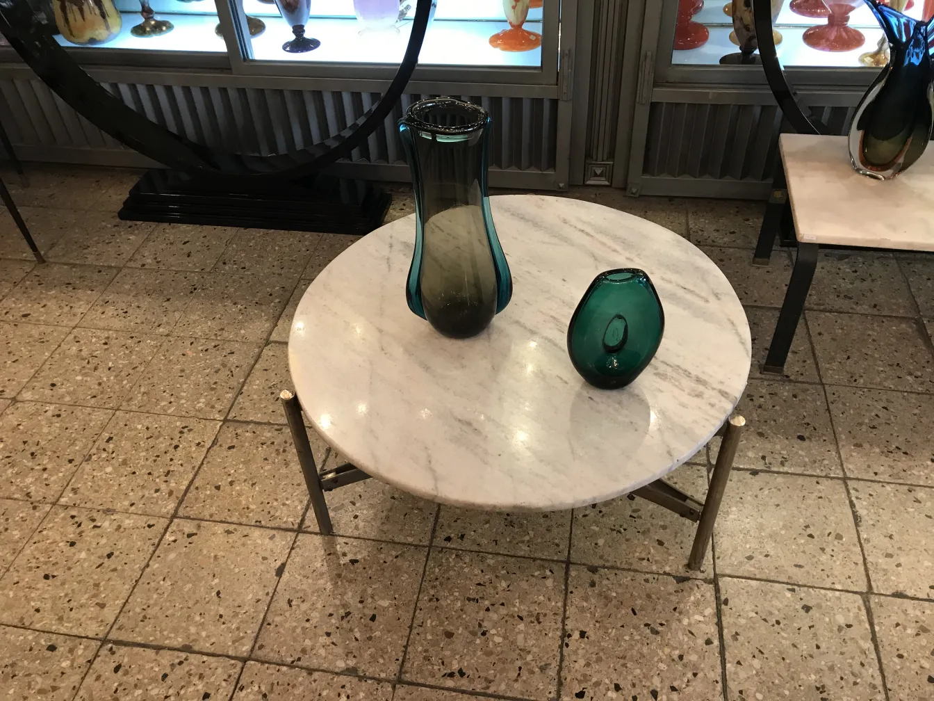 murano vase surrounded by other antiques