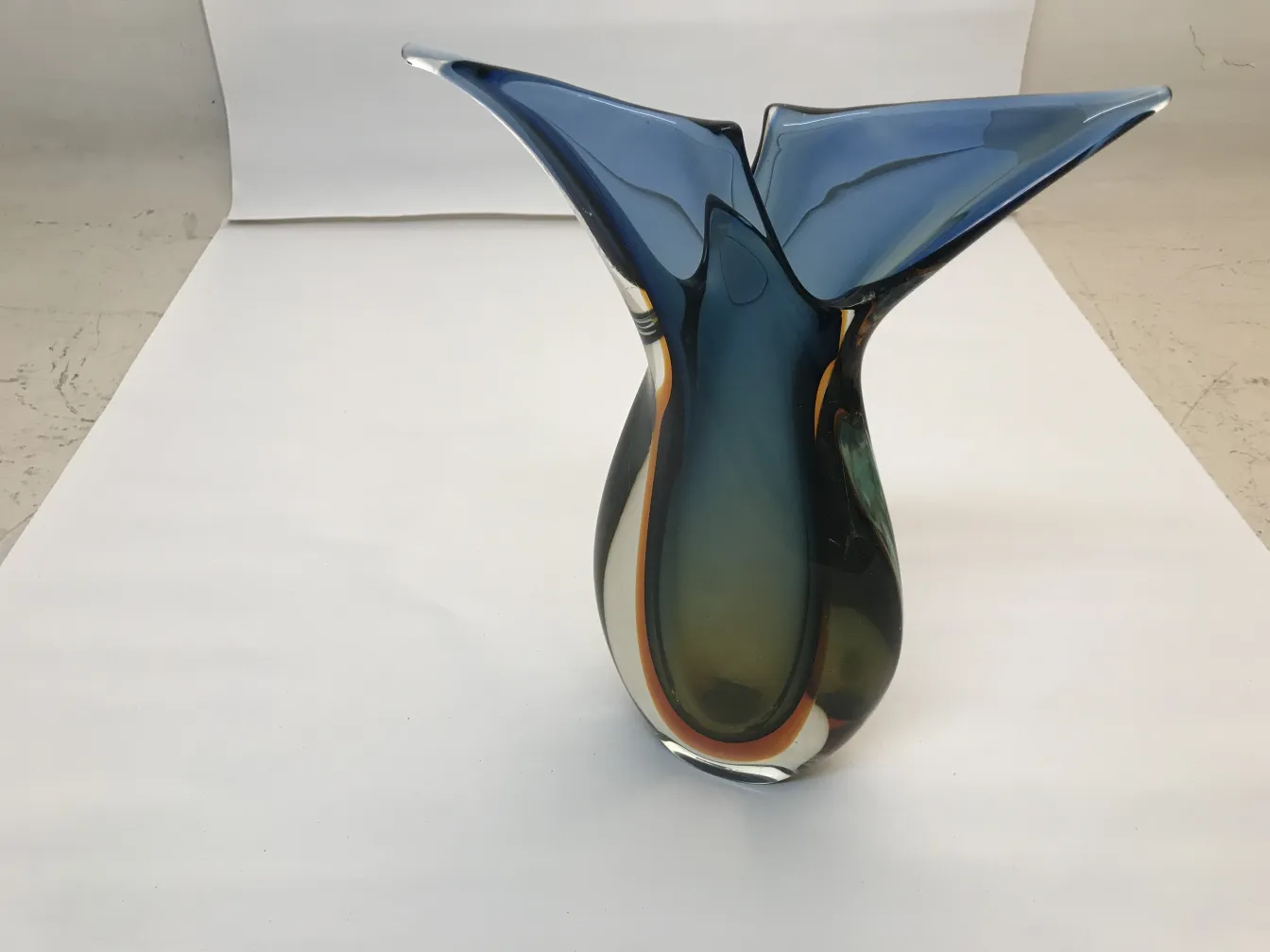 antique murano vase in blue and green shades with neutral background.