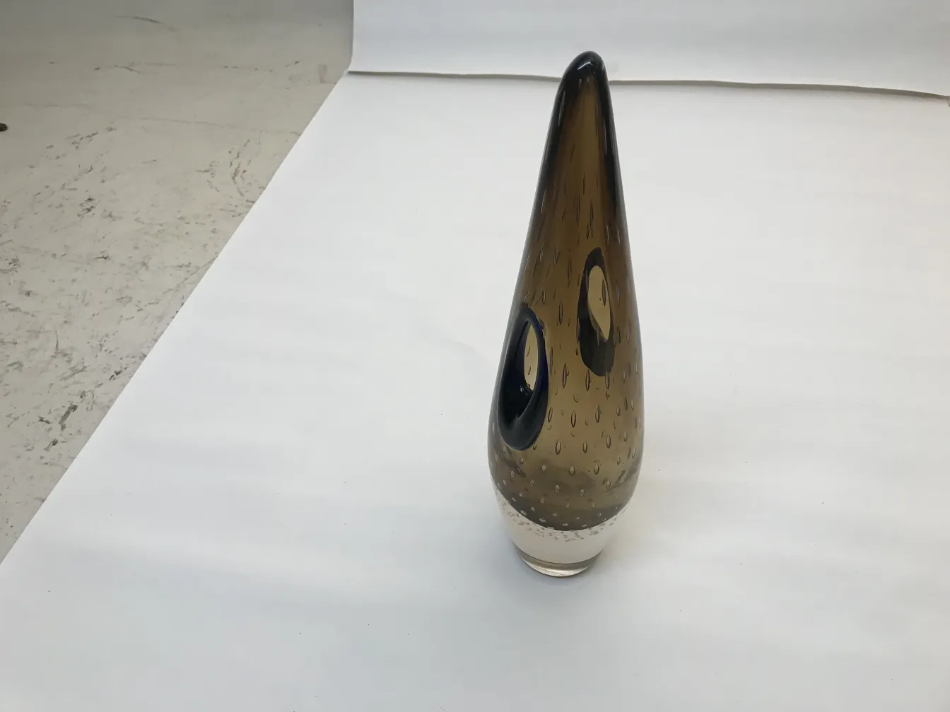 antique murano vase in smoky color, elegant with unique details, in a bright setting