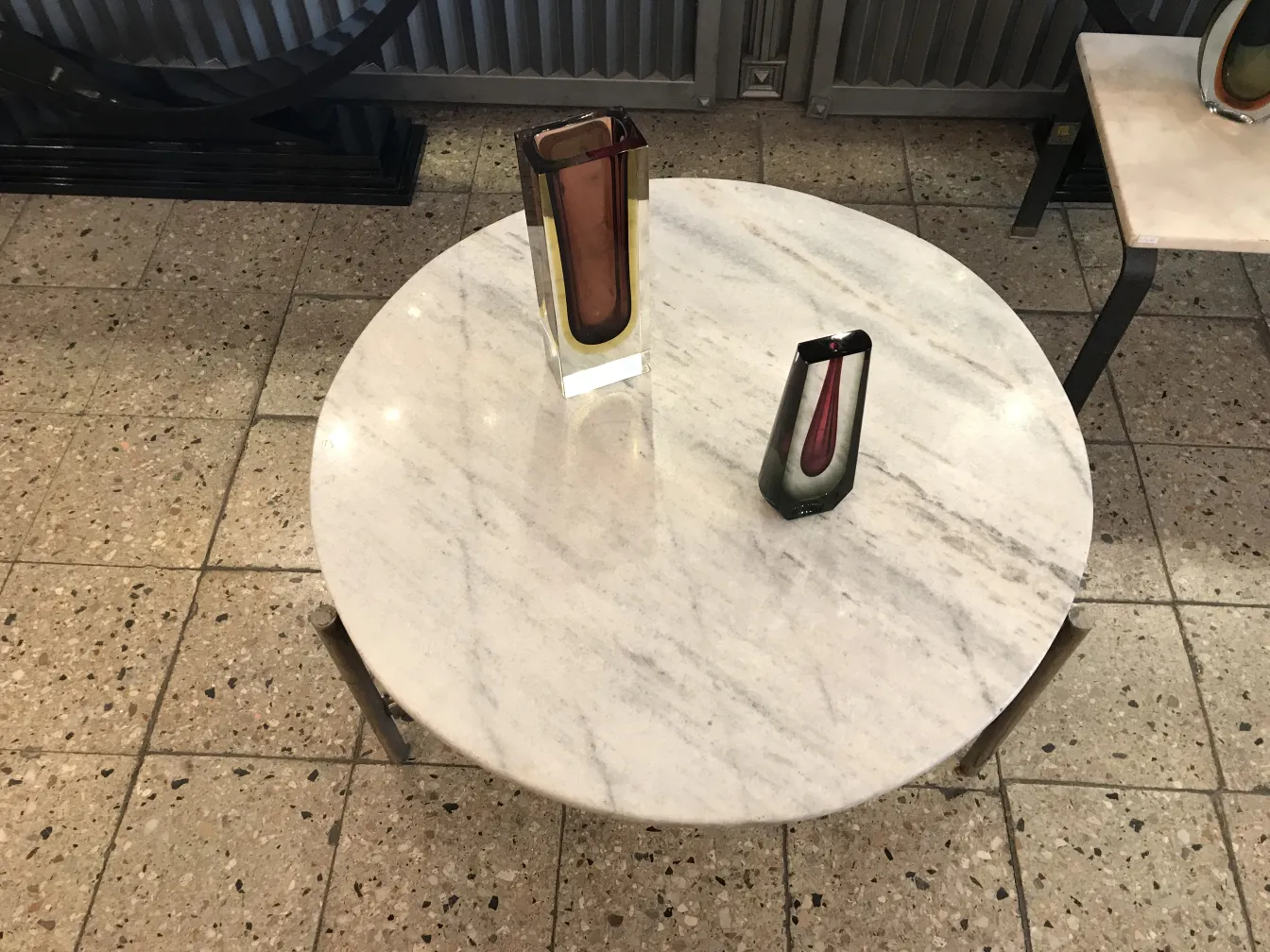 two murano vases on marble table, elegant and colorful