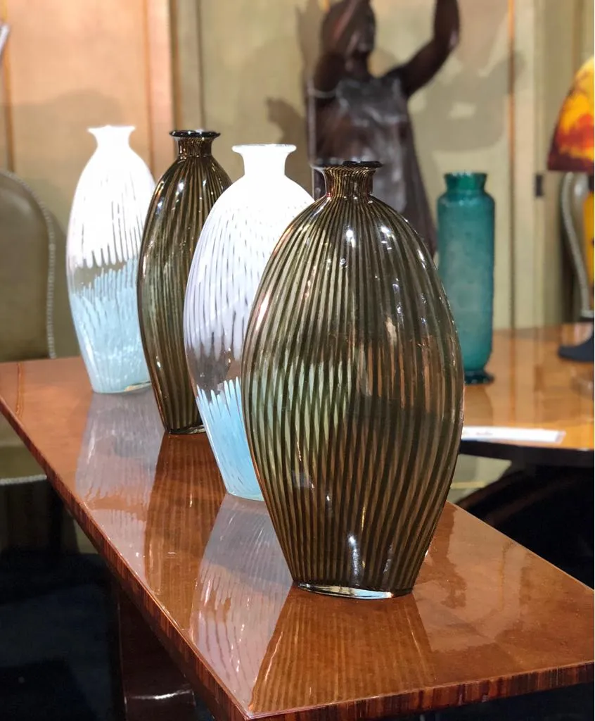 murano vases in various shapes and colors on the table