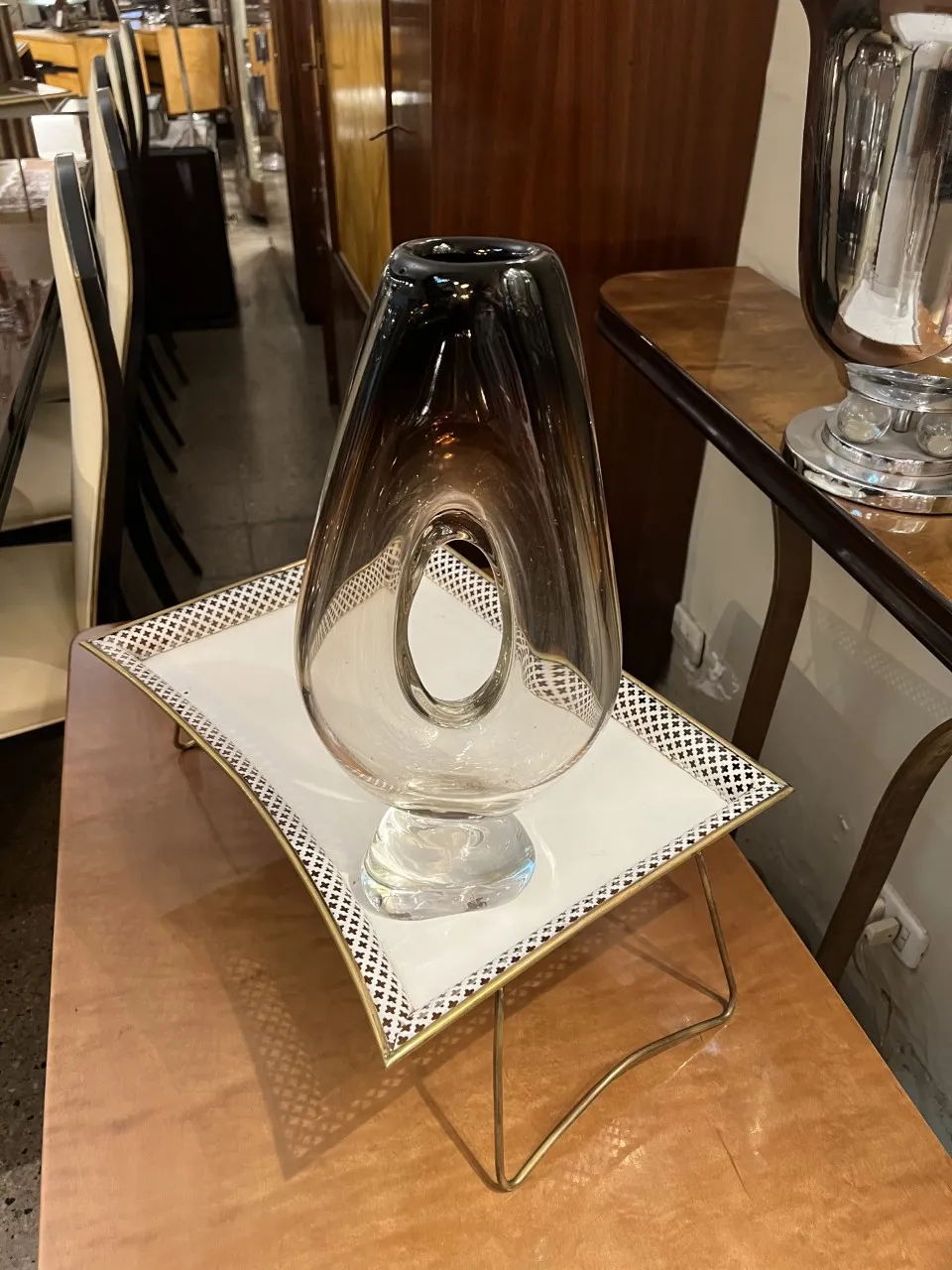 Antique Murano vase with distinctive shape and elegant details in an antique setting.