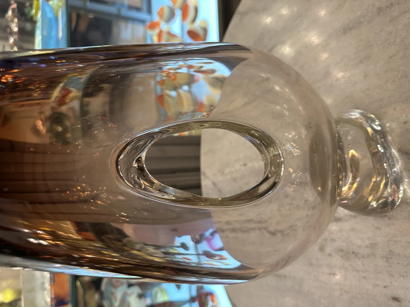 antique murano vase with oval shape and rounded base, in softly lit setting