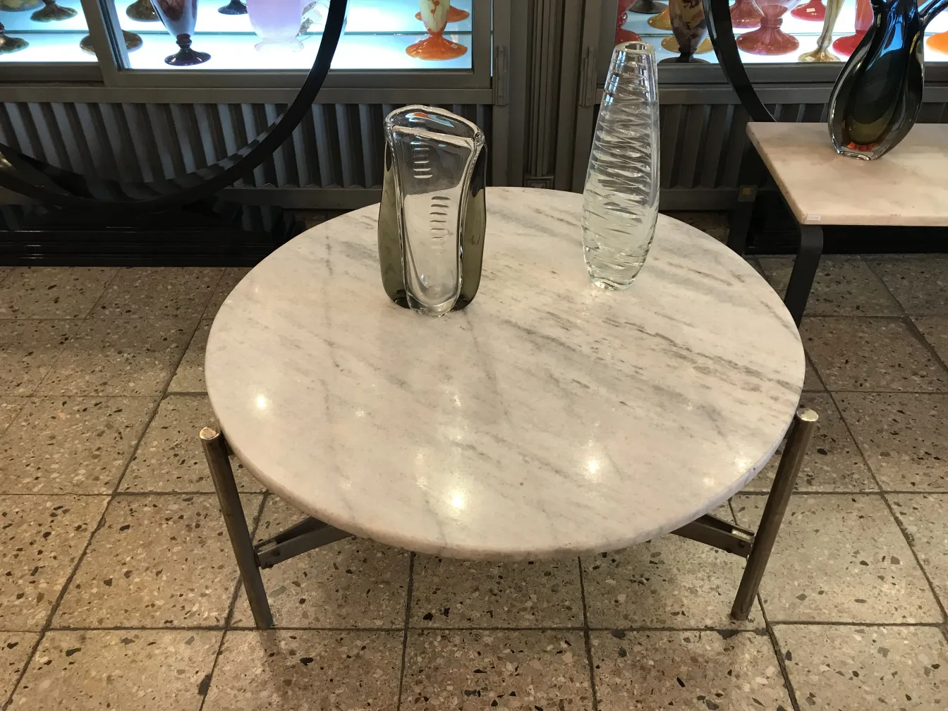 antique murano vase on a marble table along with other decorative items