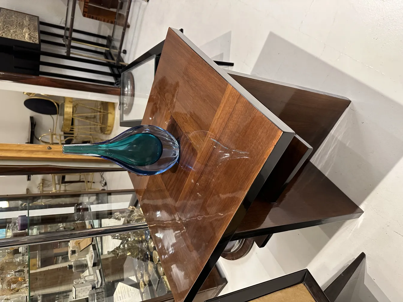 vase antique de murano sur une table en bois, entouré d'antiquités