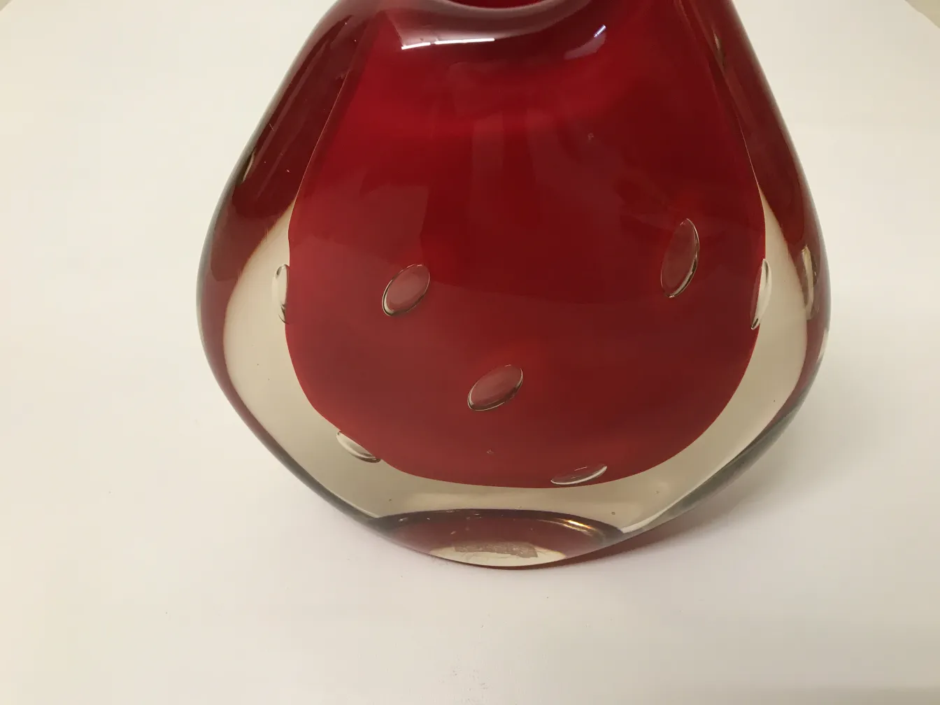 antique murano vase featuring a red design and clear accents