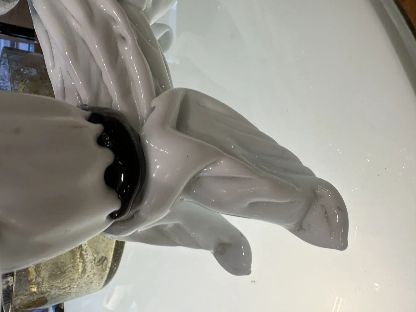 Vintage murano sculpture with white and dark detailed shapes on shiny surface