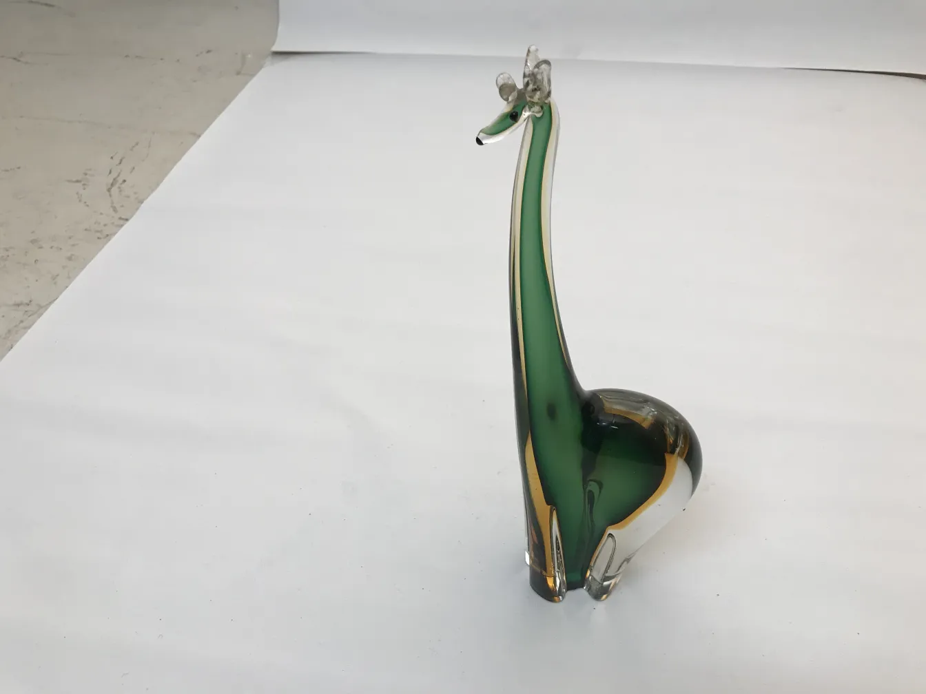 murano sculpture in animal shape on white background