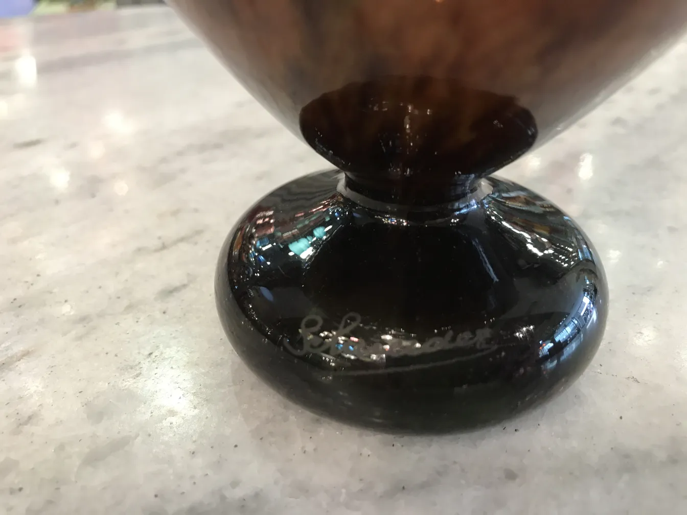 Artistic signed glass with round base, decorative item.