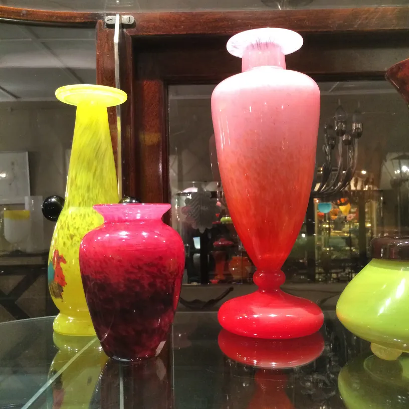 Antique glass vases signed by Schneider in vibrant colors. Cozy background.
