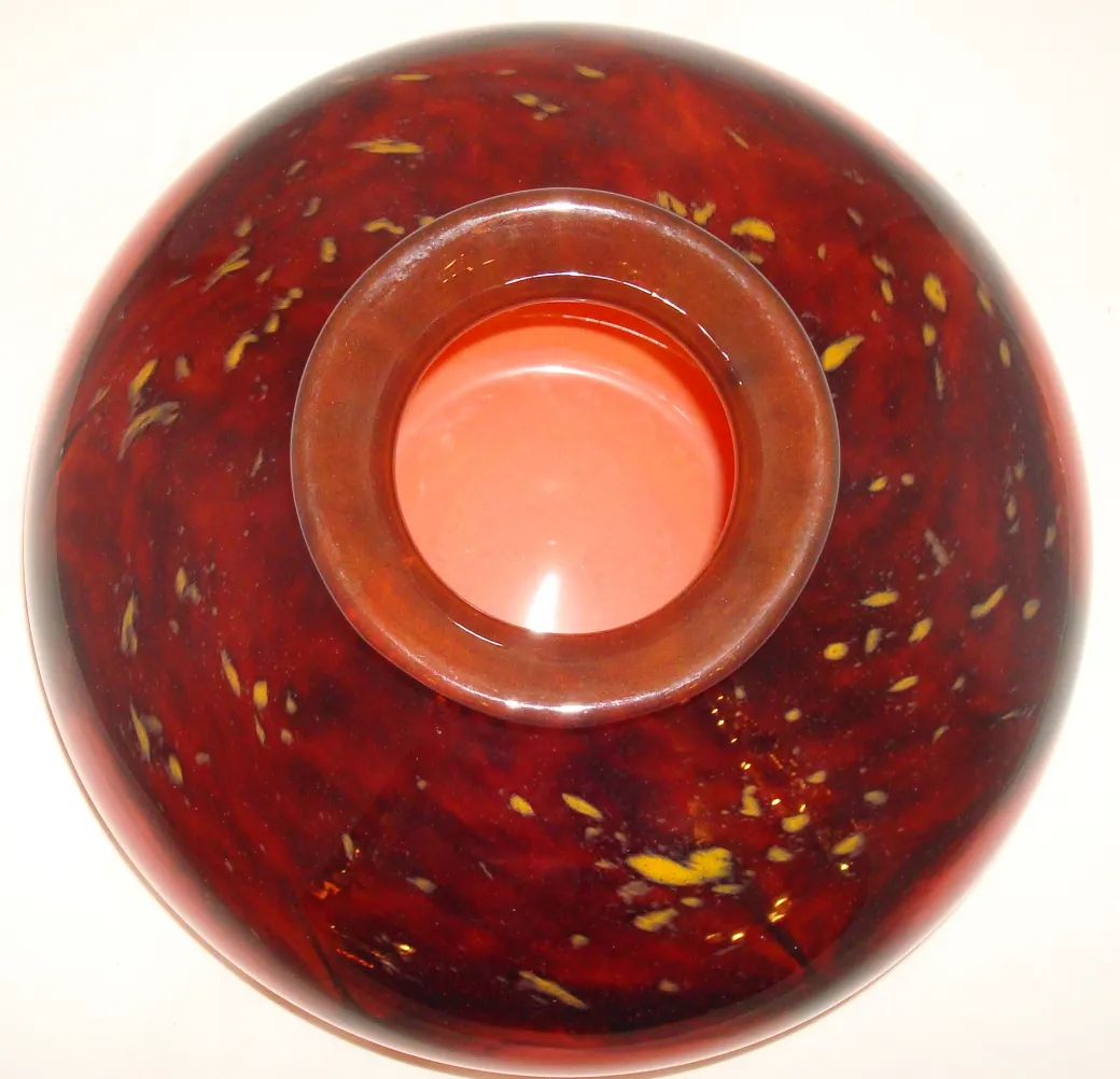 Top view of an antique signed glass Schneider in red with yellow details