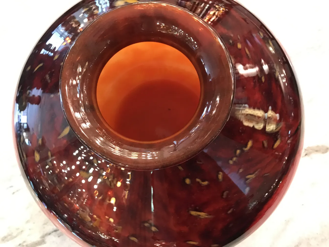 Vista dall'alto di un vetro antico firmato da Schneider, con toni caldi e dettagli sottili.